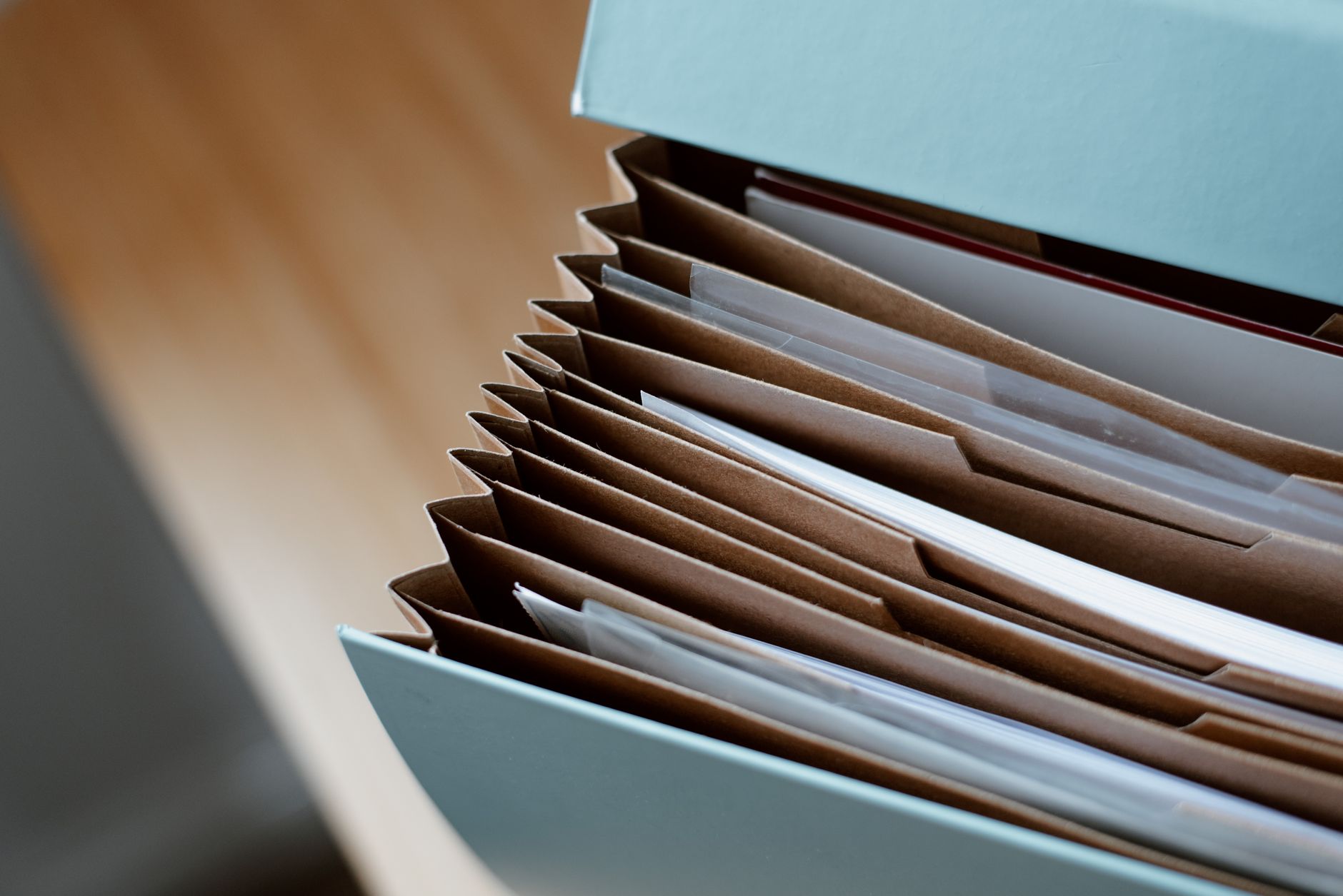 An expanding file of documents on a desk